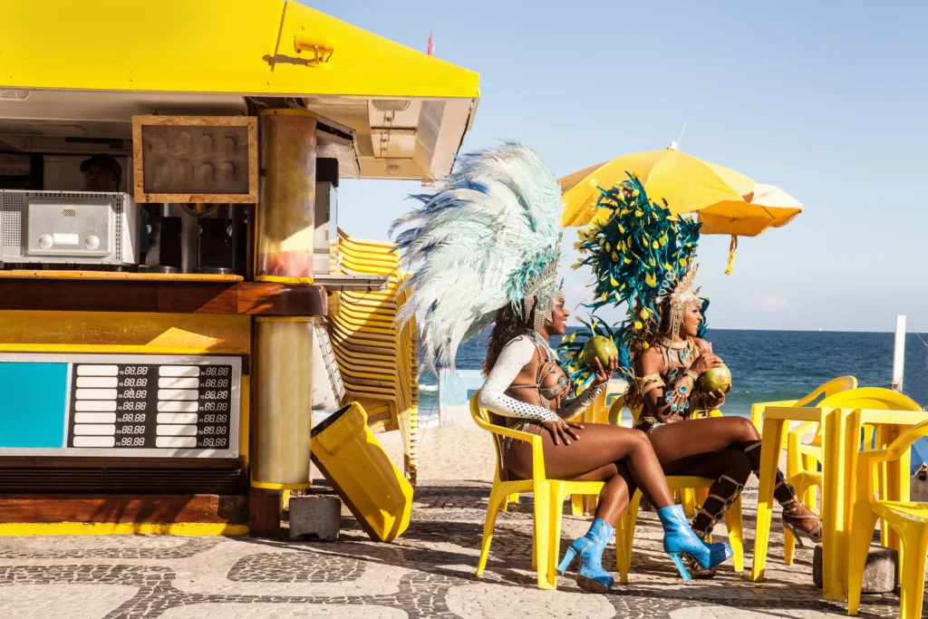 Explorando Destinos Festivos: Gastronomia e Memórias do Carnaval 4 samba dancers taking a break ipanema beach rio d 2023 11 27 05 01 05 utc – carnaval,gastronomia,celebrações,destinos festivos,explorando