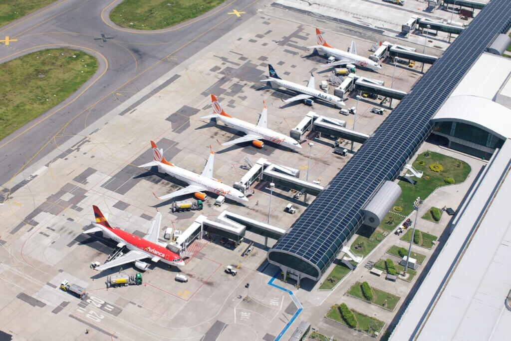 Custo de viagem para o Chile em 2026: quanto levar e como planejar 2 Vista aérea de um aeroporto com vários aviões estacionados em dia ensolarado.